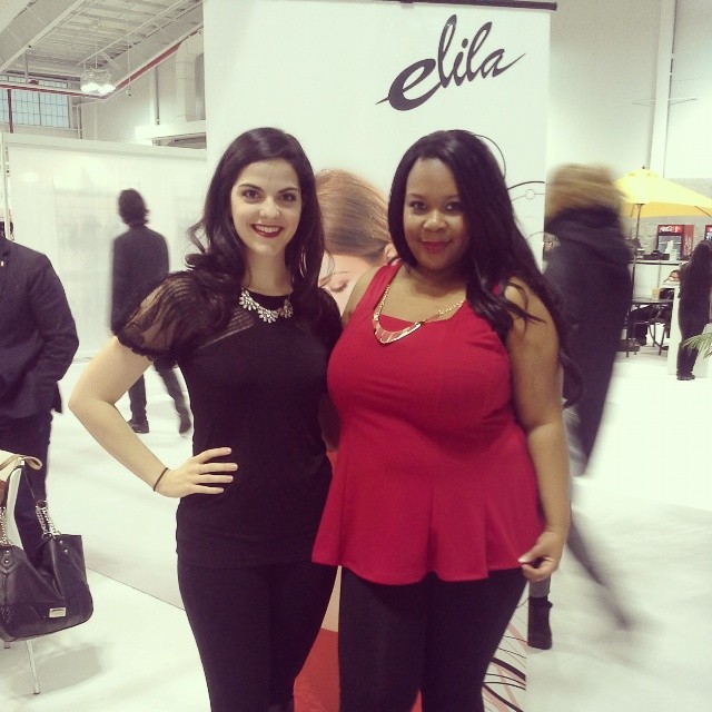 Kim Caldwell and Asia Monet pose in front of the Elila booth at the Curve Expo 2014