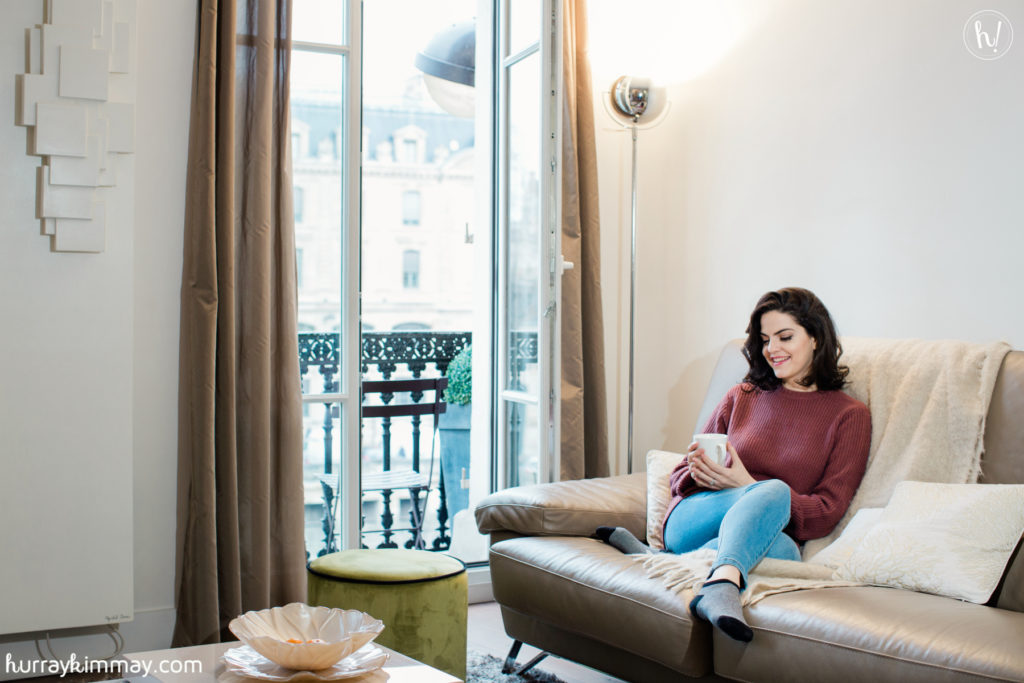 Kimmay relaxes in a cozy Tobi sweater in a beautiful Parisian Cobblestone apartment